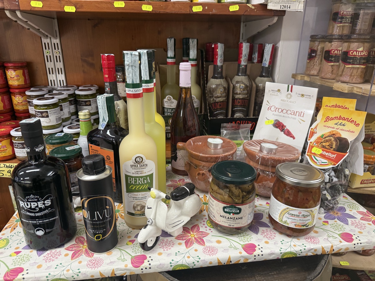 Olio, olive e specialità sott’olio calabresi disposte sul banco della bottega